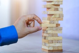 Hand removing item from wooden puzzle